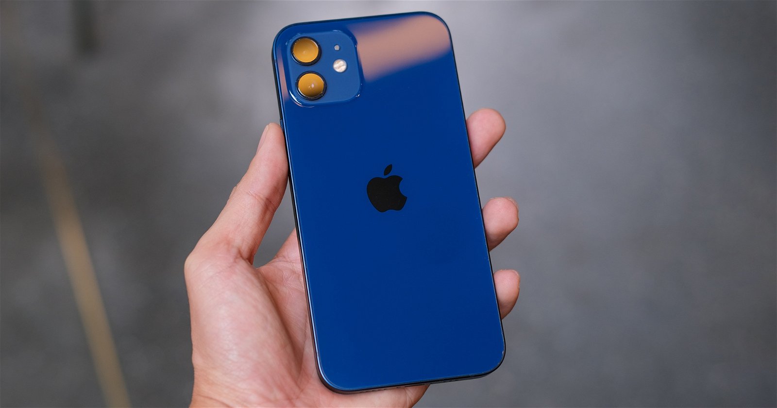 Blue iPhone 12 in hand